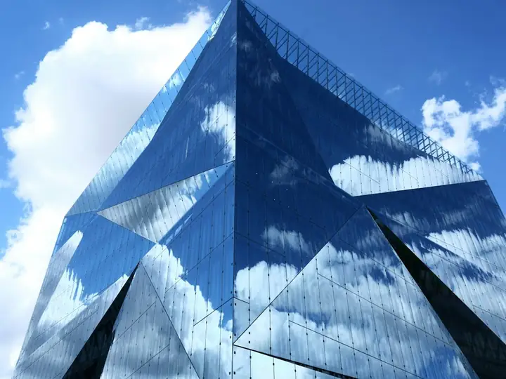 Mirrored glass building reflecting the sky
