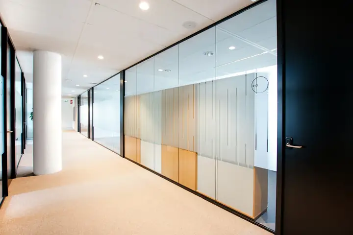 Office corridor with glass partitions and frosted bands
